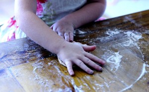 Child kneading bread dough
